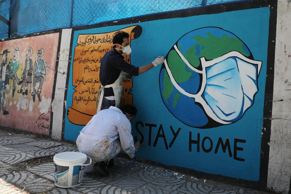 Palestinian artists draw a mural during awareness campaign about the coronavirus COVID-19, in Gaza on April 2,2020. | Majdi Fathi–NurPhoto/ Getty Images