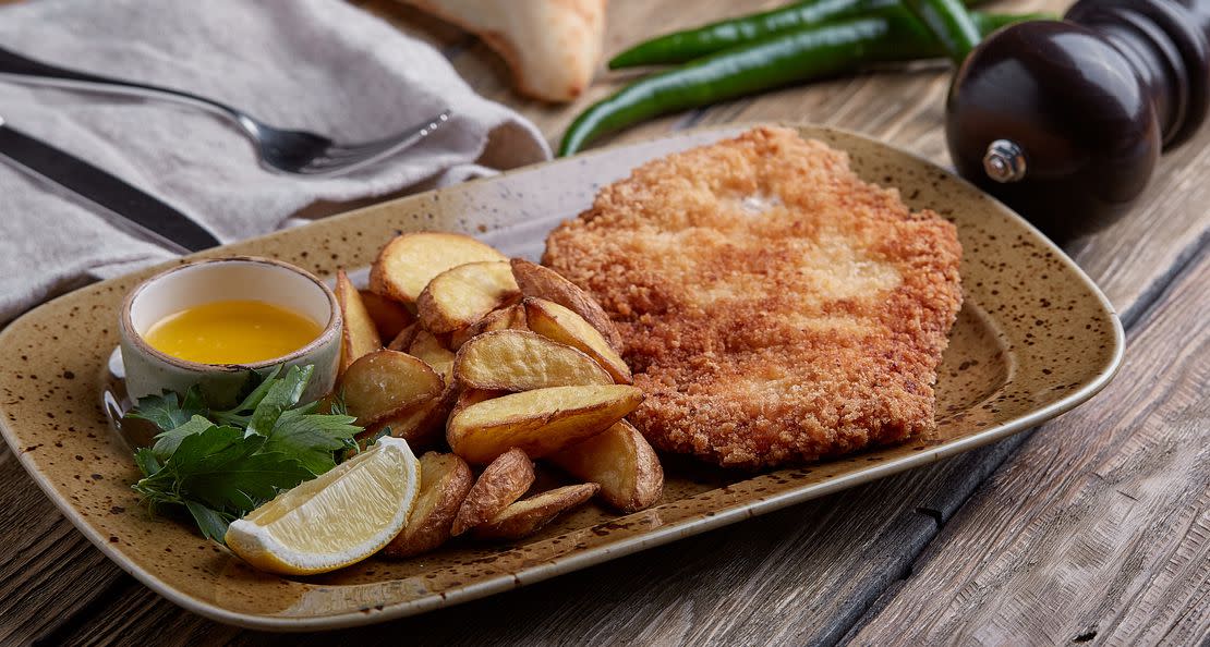 Tasty schnitzel with boiled potato. Top view, flat lay food.