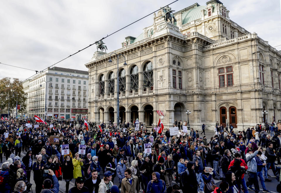 Hundreds of people take part in a demonstration against the country's coronavirus restrictions in Vienna, Austria, Saturday, Nov.20, 2021. Thousands of protesters are expected to gather in Vienna after the Austrian government announced a nationwide lockdown to contain the quickly rising coronavirus infections in the country. (AP Photo/Lisa Leutner)