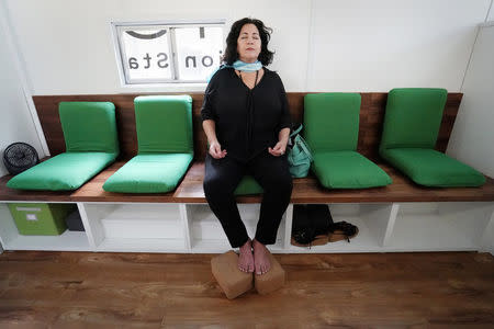 Andrea DiFiore takes part in a meditation session in a converted RV called Calm City in the Manhattan borough of New York City, New York, U.S. July 26, 2017. REUTERS/Carlo Allegri