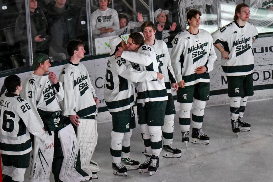 Michigan State's James Crossman, center, (24) hits teammates during the senior night ceremony after the Spartans win over Ohio State on Saturday, Feb. 24, 2024, at Munn Arena in East Lansing.