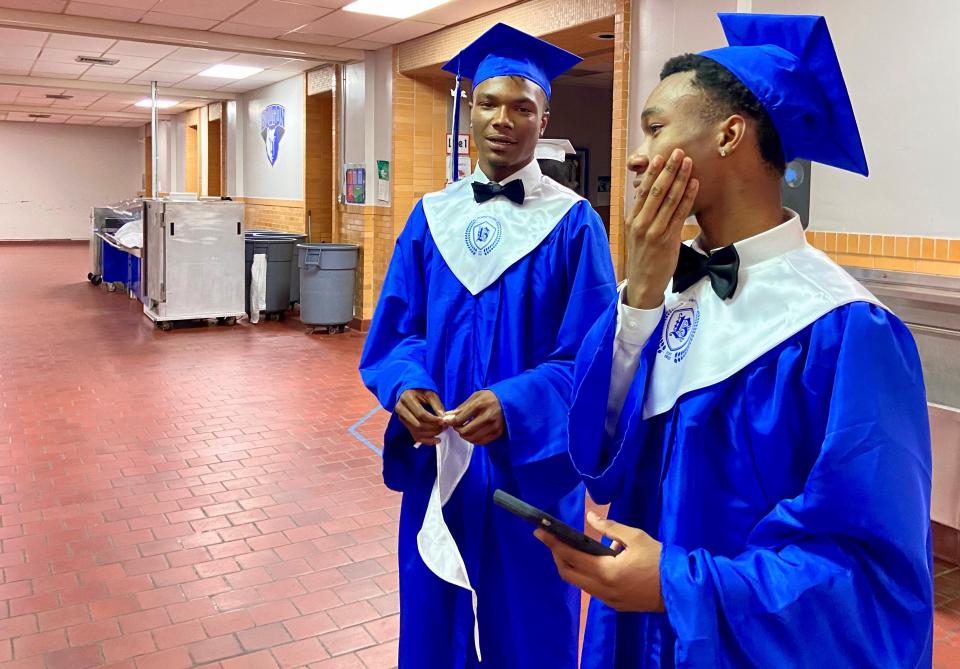 Joseph Jenkins (left) and Demmetric Toney talk in Bolton High School's cafeteria before Monday's commencement.