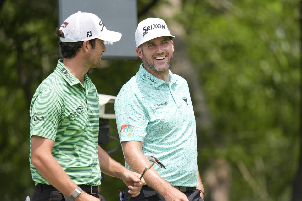 Taylor Pendrith, right, laughs with fellow competitor Davis Riley, left, at the second hole tee box during the third round of the Byron Nelson golf tournament in McKinney, Texas, Saturday, May 4, 2024. (AP Photo/LM Otero)