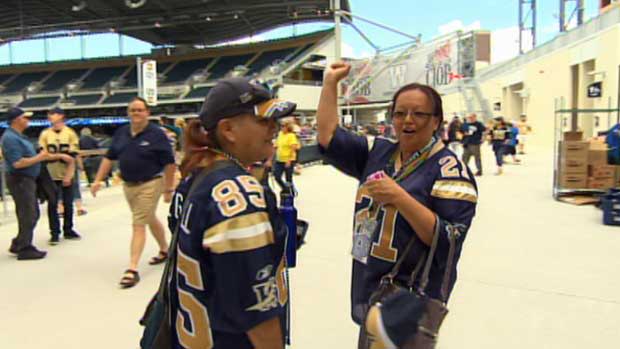 Winnipeg Blue Bombers fans celebrate the team's first game at Investors Group Field on Wednesday evening.