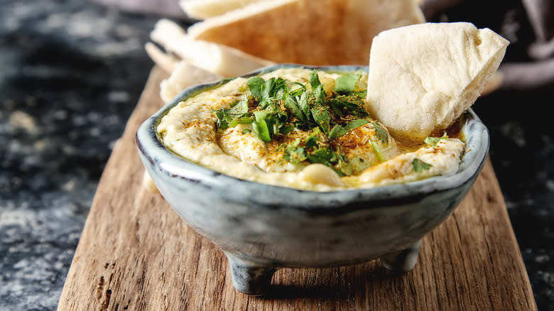 hummus topped with herbs 