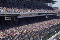 Fans fill the stands during the Indianapolis 500 auto race at Indianapolis Motor Speedway in Indianapolis, Sunday, May 30, 2021. About 135,000 spectators are admitted to the track, for the largest sports event since the start of the pandemic. It's about 40% of attendance and leaves 100,000 empty seats in the permanent grandstands. (AP Photo/Paul Sancya)