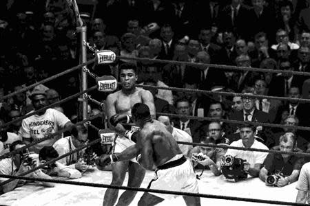 Cassius Clay (L) and Sonny Liston face off in a WBA/WBC World Heavyweight fight in this Miami Herald photo from HistoryMiami taken in Miami Beach, Florida February 25, 1964. REUTERS/Miami Herald/HistoryMiami/Handout