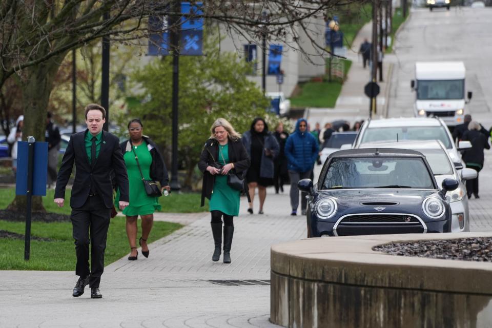 Clad in Brigid Kelly's signature green, mourners arrive Thursday for the funeral of the former Hamilton County auditor Thursday. Kelly died last month at age 40 from esophageal cancer.