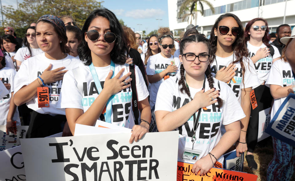 <p>Students listen to the national anthem while rallying in the street during the March for Our Lives event demanding stricter gun control at the Miami Beach Senior High School, in Miami, Fla. (Photo: Javier Galeano/Reuters) </p>