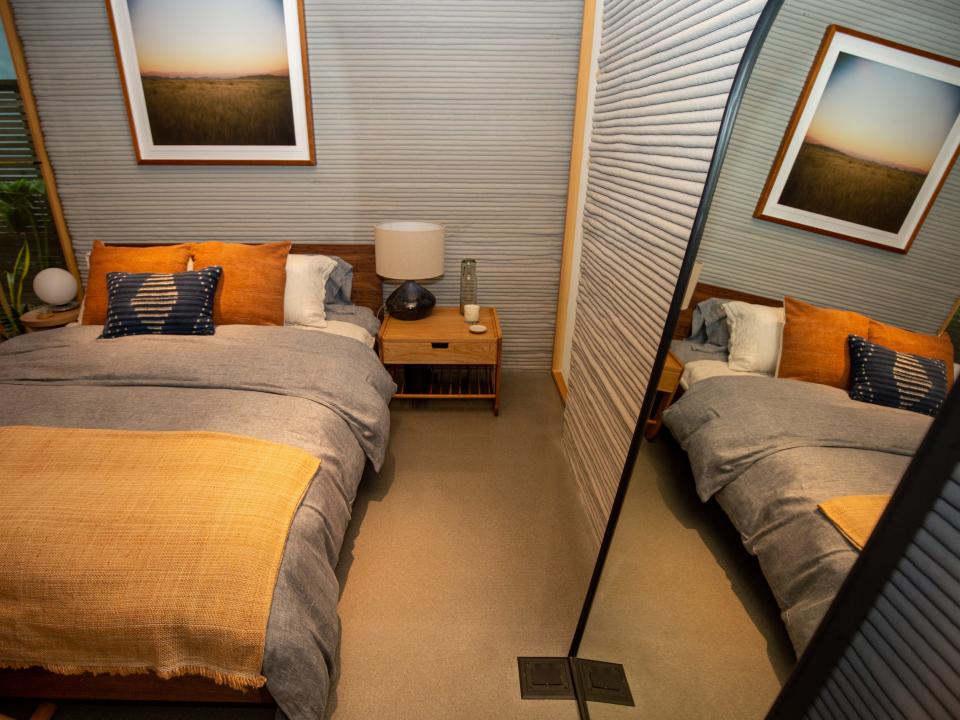 Inside Icon's over 2,000-square-foot House Zero in Austin. There's a bed next to a mirror.