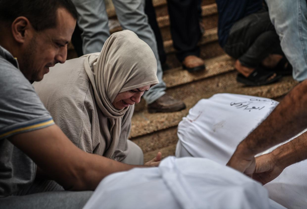 A man and woman mourn at Nasser Hospital, Gaza, following Israeli airstrikes on Khan Yunis (Anadolu via Getty Images)