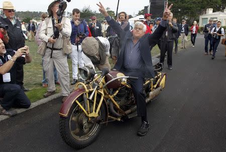 TV personality Jay Leno reacts after he successfully rode a 1930 Bohmerland motorcycle around the grounds during the Concours d'Elegance at the Pebble Beach Golf Links in Pebble Beach, California, August 17, 2014. REUTERS/Michael Fiala