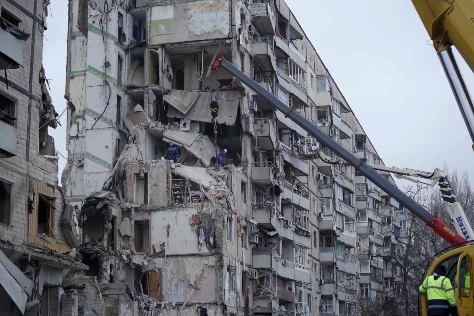 Rescuers search a residential building destroyed after a missile strike in Dnipro, Ukraine.