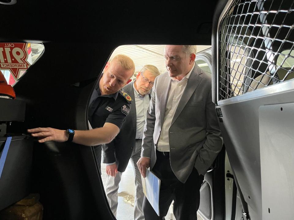 Island EMS general manager James Orchard, left, shows off one of the company's new Community Paramedic Response Units to P.E.I.'s director of director of emergency health services Scott Cameron, centre, and Health Minister Mark McLane.