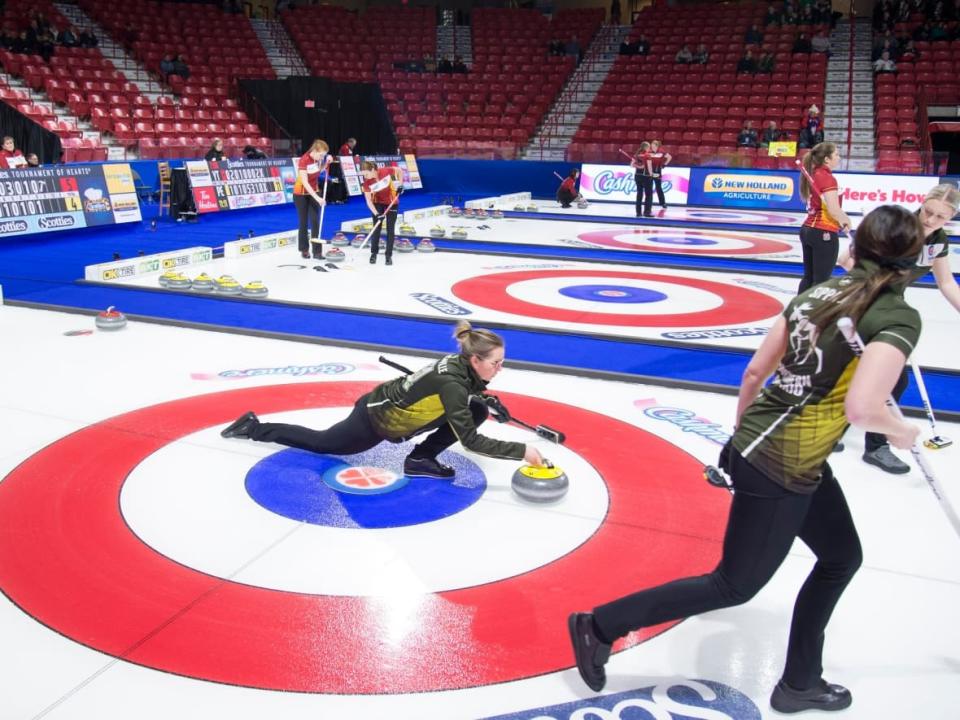 Northern Ontario skip Krista McCarville delivers a rock during a previous year's Scotties Tournament of Hearts. Curling Canada announced Thursday the 2022 event will go ahead in Thunder Bay, Ont., at the Fort William Gardens, but whether fans can attend is still up in the air.  (Jonathan Hayward/The Canadian Press - image credit)