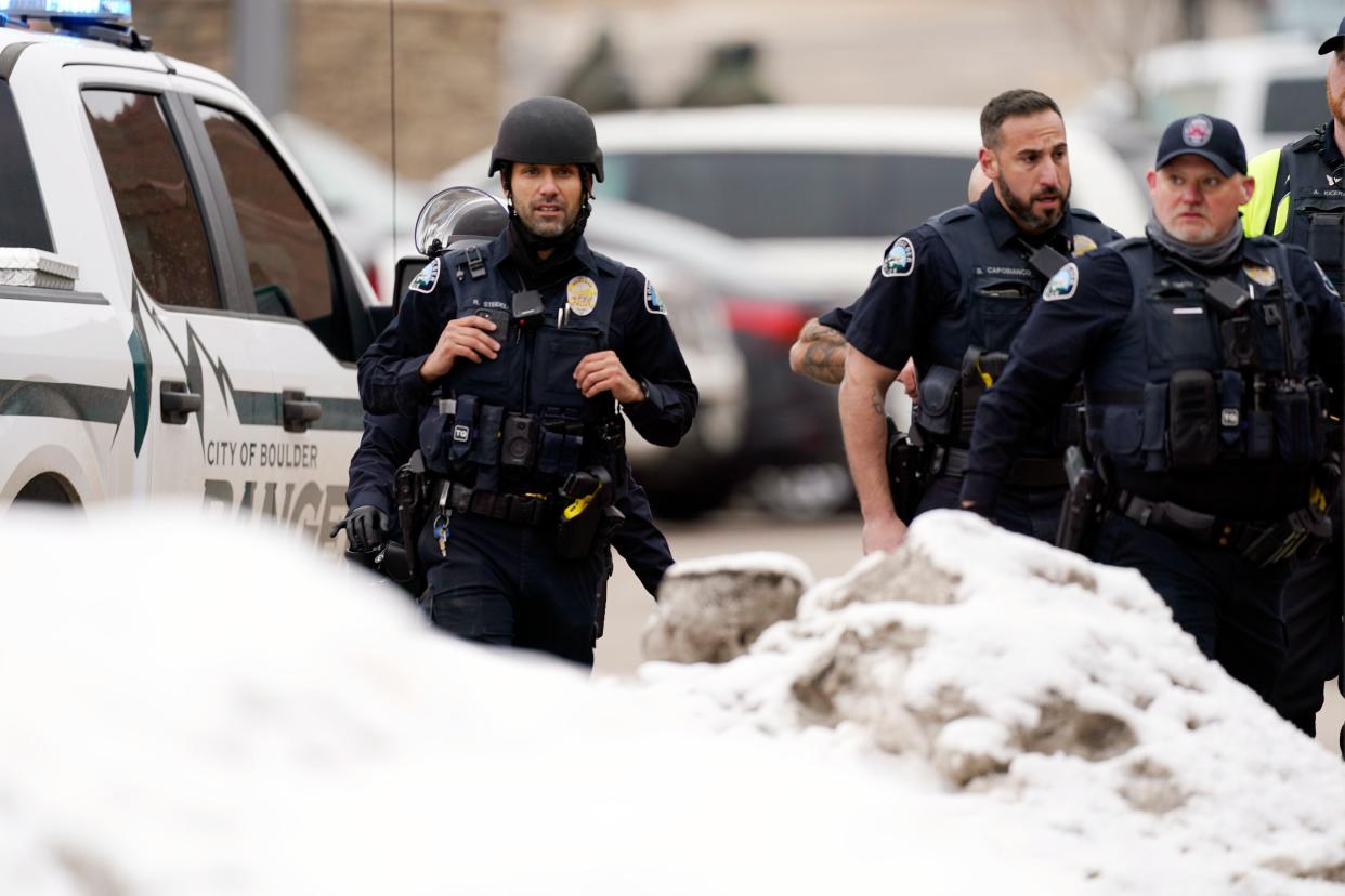 Police stand outside a King Soopers grocery store where a shooting took place Monday, March 22, 2021, in Boulder, Colo.