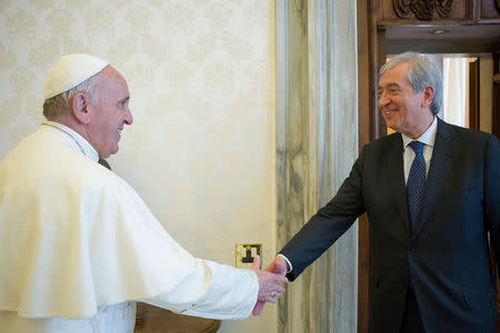 Pope Francis is greeted by Libero Milone (R), the Vatican's auditor general, during a meeting at the Vatican, April 1, 2016. Picture taken April 1 2016. Osservatore Romano/Handout via REUTERS