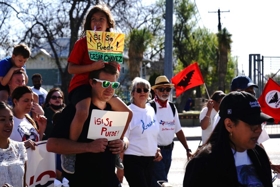 At 10:00 a.m., more than 100 attendees marched for half an hour with "sí se puede" signs and photos of César Chávez before hearing speeches from elected officials and community leaders.