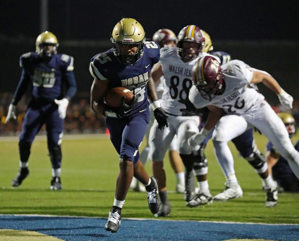 Hoban running back Caleb Jones runs for a touchdown against Walsh Jesuit during the first half Friday in Akron.