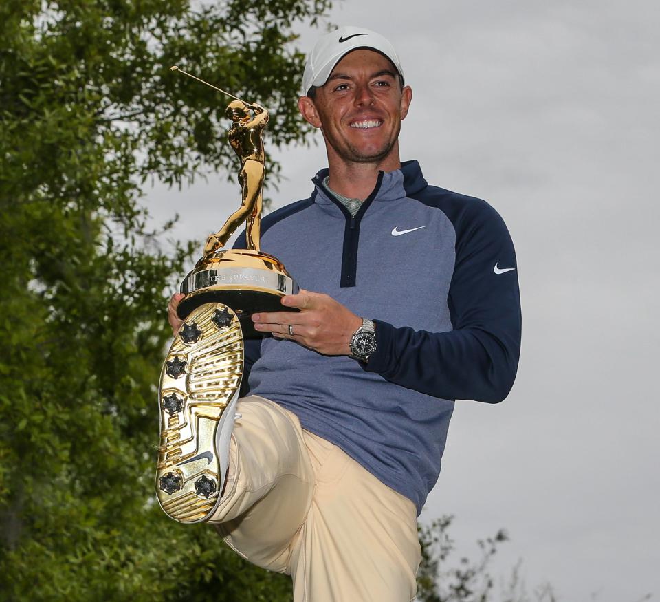 Rory McIlroy shows off his Gold Man trophy for winning the 2019 Players Championship -- and his gold-soled shoes.