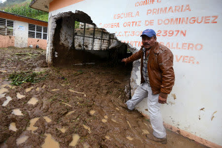 A resident shows a classroom damaged by a mudslide following heavy showers caused by the passing of Tropical Storm Earl, in the town of Temazolapa, in Veracruz state, Mexico, August 6, 2016. REUTERS/Oscar Martinez