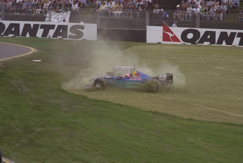 Johnny Herbert of Great Britain and Jacques Villeneuve of Canada spin off the track after a collision on the first corner during the 1997 Australian Grand Prix.