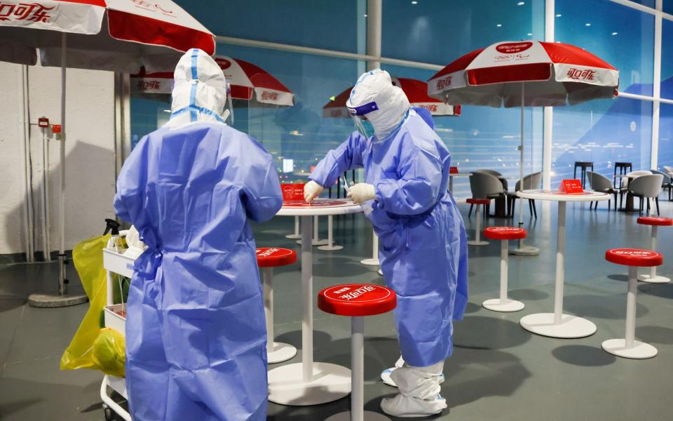 Employees disinfect surfaces at the Beijing 2022 Main Media Centre - Getty Images