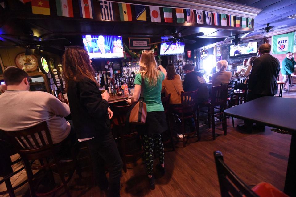 Customers grab some food and drink at The Harp in Wilmington in 2020.