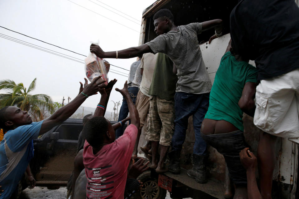 People reach for&nbsp;supplies from a truck&nbsp;on&nbsp;Oct. 14, 2016.