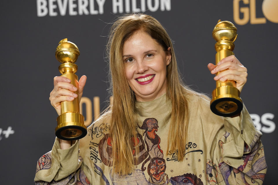 Justine Triet poses with the awards for best screenplay, motion picture for "Anatomy of a Fall" and for best motion picture, foreign language for "Anatomy of a Fall" in the press room at the 81st Golden Globe Awards on Sunday, Jan. 7, 2024, at the Beverly Hilton in Beverly Hills, Calif. (AP Photo/Chris Pizzello)