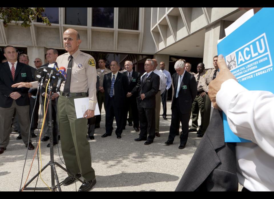 Los Angeles County Sheriff Lee Baca,at podium, takes questions about a report released by the American Civil Liberties Union, ACLU, outside Sheriff's headquarters Wednesday, Sept. 28, 2011, in Los Angeles. The ACLU demanded earlier Wednesday that federal authorities investigate allegations of brutality by deputies at Los Angeles County jails. (AP Photo/Damian Dovarganes)