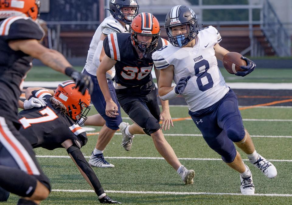 Hudson running back Ian Ludewig cuts back against the Hoover defense Friday in North Canton.