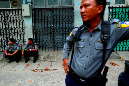 FILE PHOTO: Police officers guard a Muslim residential area in Mandalay July 3, 2014. REUTERS/Soe Zeya Tun/File Photo