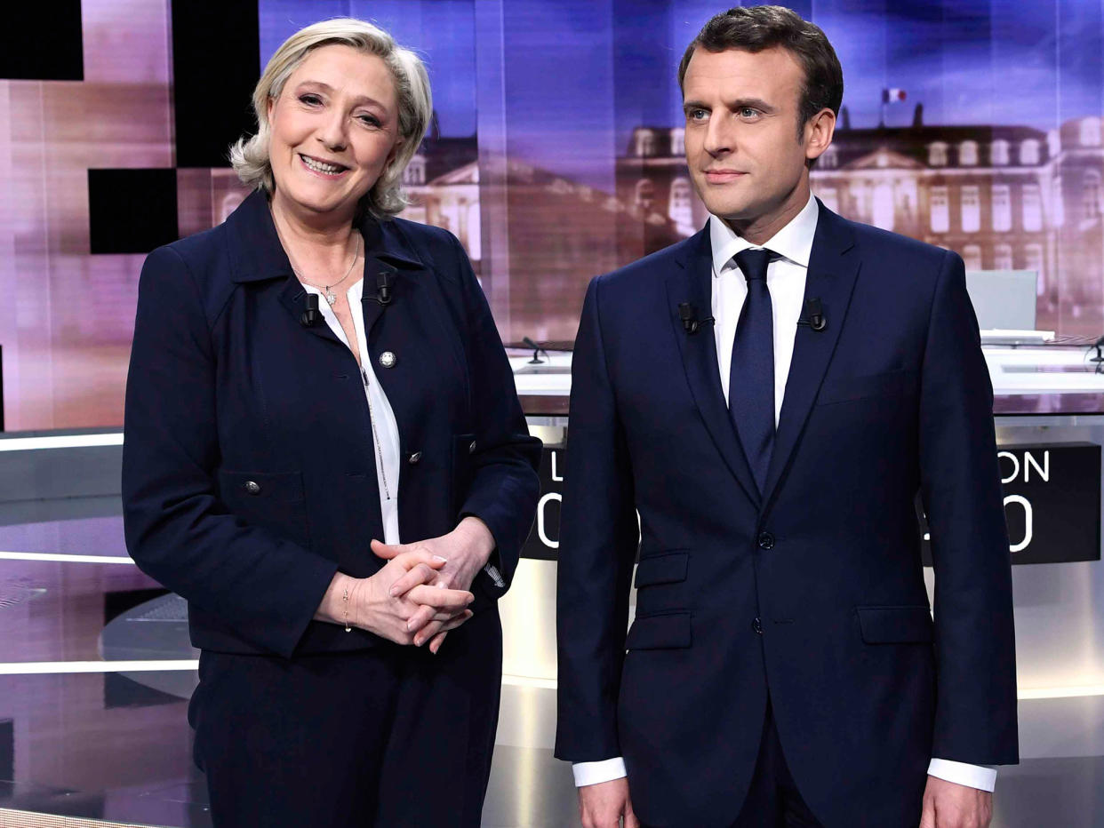 Emmanuel Macron and Marine Le Pen pose prior to the start of a television debate on 3 May: AFP/Getty Images