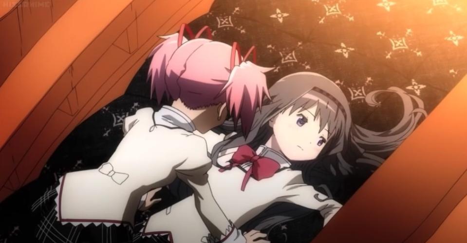 Madoka anxiously hovers over a pinned Homura