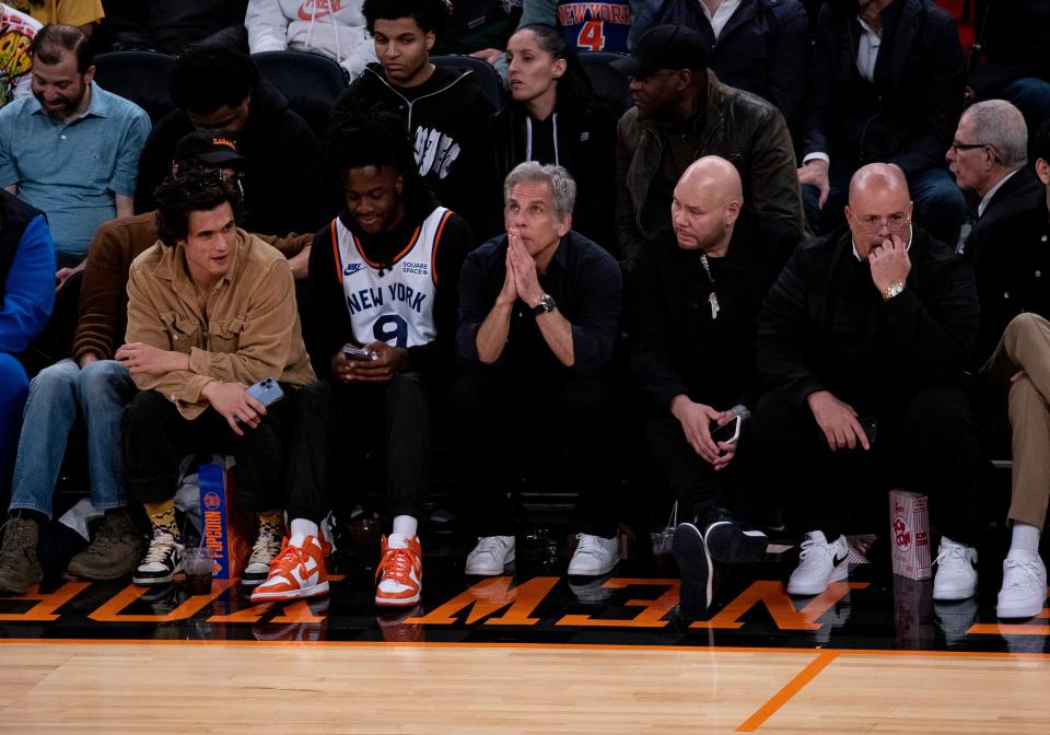 Courtside at a Knicks game, alongside some New York Icons, in Fragment Design x Travis Scott x Air Jordan 1 Lows.