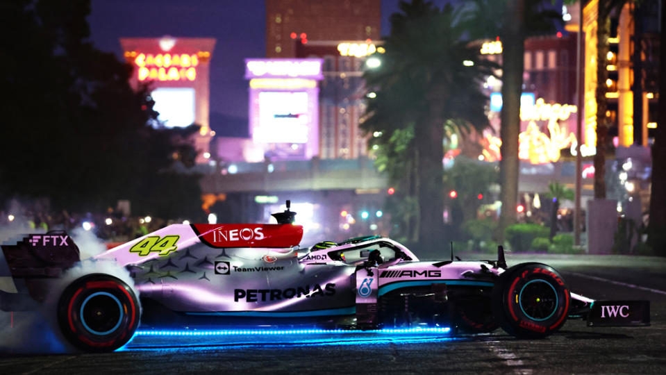 Lewis Hamilton drives his Mercedes-AMG Petronas race car on the Las Vegas Strip as part of the Formula 1 Las Vegas Grand Prix 2023 launch party.
