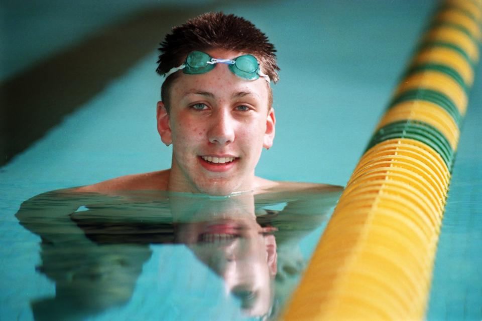 Mark Gangloff poses for a portrait at the Firestone High School pool during his time as a Falcons swimmer from 1996-2000. He won four Division I state championships, three in the 100 breaststroke and one in the 200 individual medley.