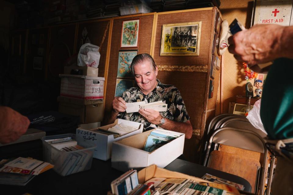 Marshall Pumphrey looks through a collection of postcards