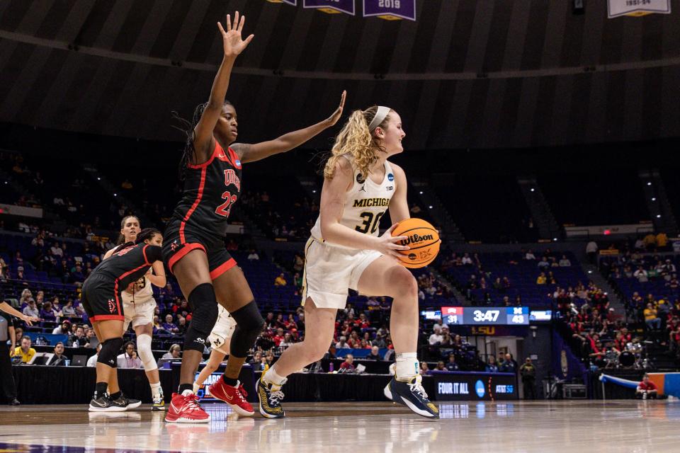 Michigan Wolverines guard Elise Stuck (30) looks to pass against UNLV Rebels center Desi-Rae Young (23)  during the second half in the women's NCAA tournament at Pete Maravich Assembly Center in Baton Rouge, Louisiana, on Friday, March 17, 2023.