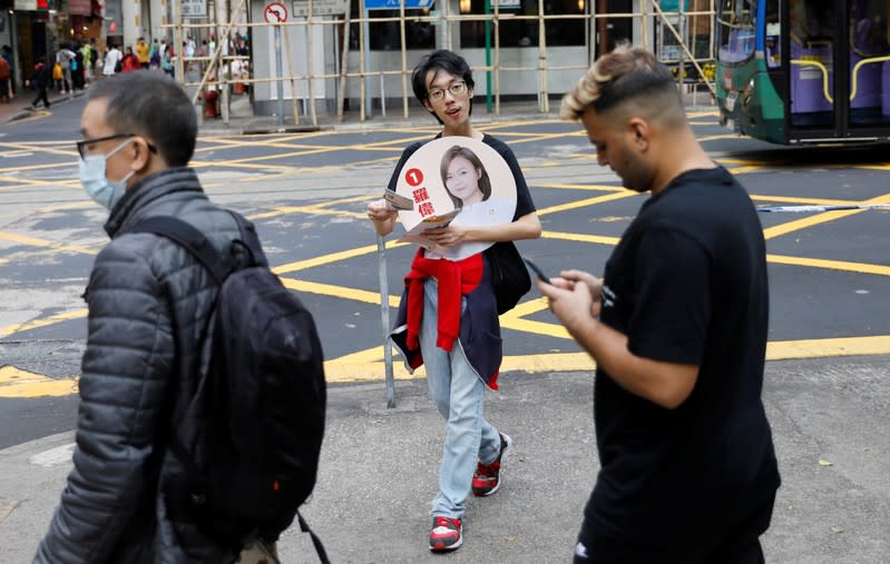 A man campaigns for candidate Susi Law ahead of district council elections in Hong Kong