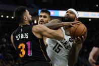 Milwaukee Bucks' DeMarcus Cousins is fouled by Miami Heat's Max Strus during the second half of an NBA basketball game Saturday, Dec. 4, 2021, in Milwaukee. (AP Photo/Morry Gash)