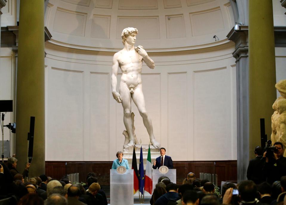 German Chancellor Angela Merkel, left, and Italian Prime Minister Matteo Renzi speak during a press conference in front of Michelangelo's "David statue" after their bilateral summit in Florence, Italy, on Jan. 23, 2015. T