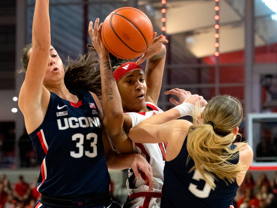 UConn’s Paige Bueckers (5) draws an offensive foul against N.C. State’s Aziaha James during the first half of the Wolfpack’s game on Sunday, Nov. 12, 2023, at Reynolds Coliseum in Raleigh, N.C. Kaitlin McKeown/kmckeown@newsobserver.com