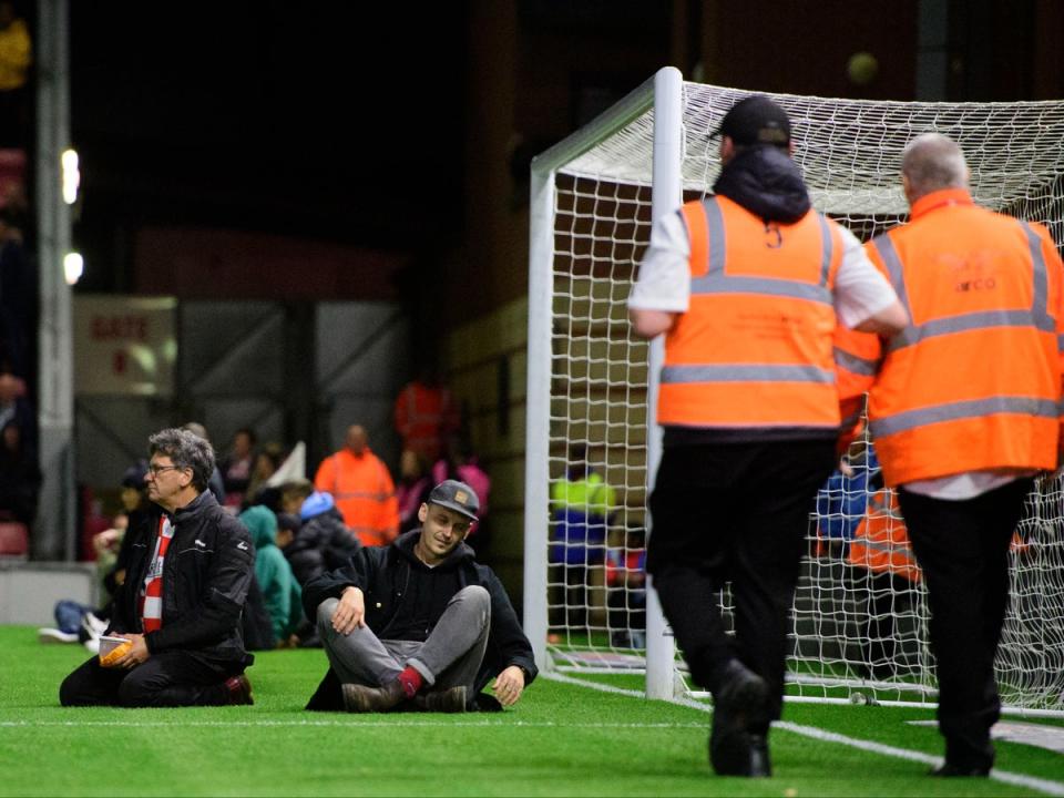 Fans sat in the goalmouth to get attention to Mr Reynold’s plight (Getty)