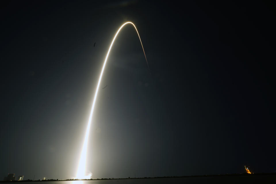 In this time-exposure photograph, a SpaceX Falcon 9 rocket with the 25th batch of approximately 60 satellites for SpaceX's Starlink broadband network lifts off from the Space Launch Complex 40 at the Cape Canaveral Space Force Station in Cape Canaveral, Fla., late Wednesday, April 28, 2021. (AP Photo/John Raoux)