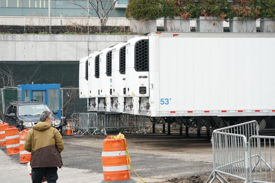 Refrigeration trucks are in place as workers build a makeshift morgue outside of Bellevue Hospital to handle an expected surge in Coronavirus victims on March 25, 2020 in New York.