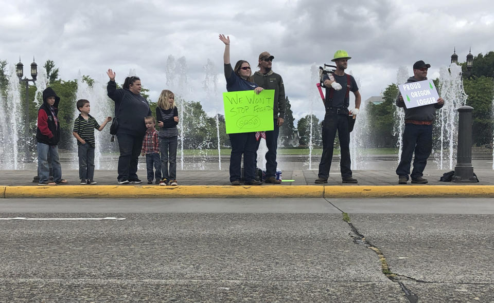 Loggers protest outside the Oregon State House in Salem, Oregon, on June 20, 2019, the day the Senate is scheduled to take up a bill that would create the nation's second cap-and-trade program to curb carbon emissions. Senate Republicans, however, pledged to walk out so there wouldn't be enough lawmakers present for a vote on House Bill 2020, which is extremely unpopular among loggers, truckers and many rural voters. (AP Photo/Gillian Flaccus)