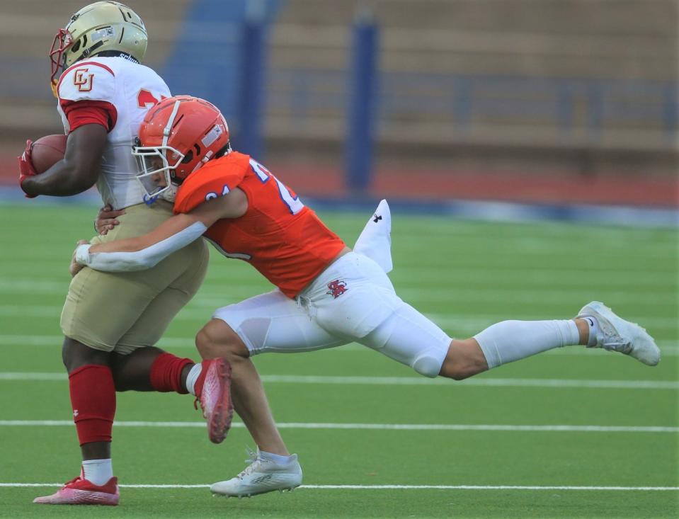 A San Angelo Central High School player tries to tackle a Lubbock Coronado player during a preseason scrimmage at San Angelo Stadium on Thursday, Aug. 18, 2022.