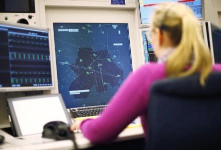 An operator of Swiss air traffic control firm Skyguide monitors airplanes at the Skyguide monitoring centre in Duebendorf, near Zurich, April 3, 2013. Skyguide held its annual news conference today. REUTERS/Michael Buholzer (SWITZERLAND - Tags: TRANSPORT BUSINESS)